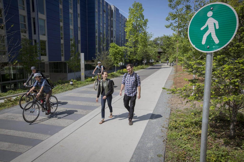 photo of walkers and bicycle riders sharing a path